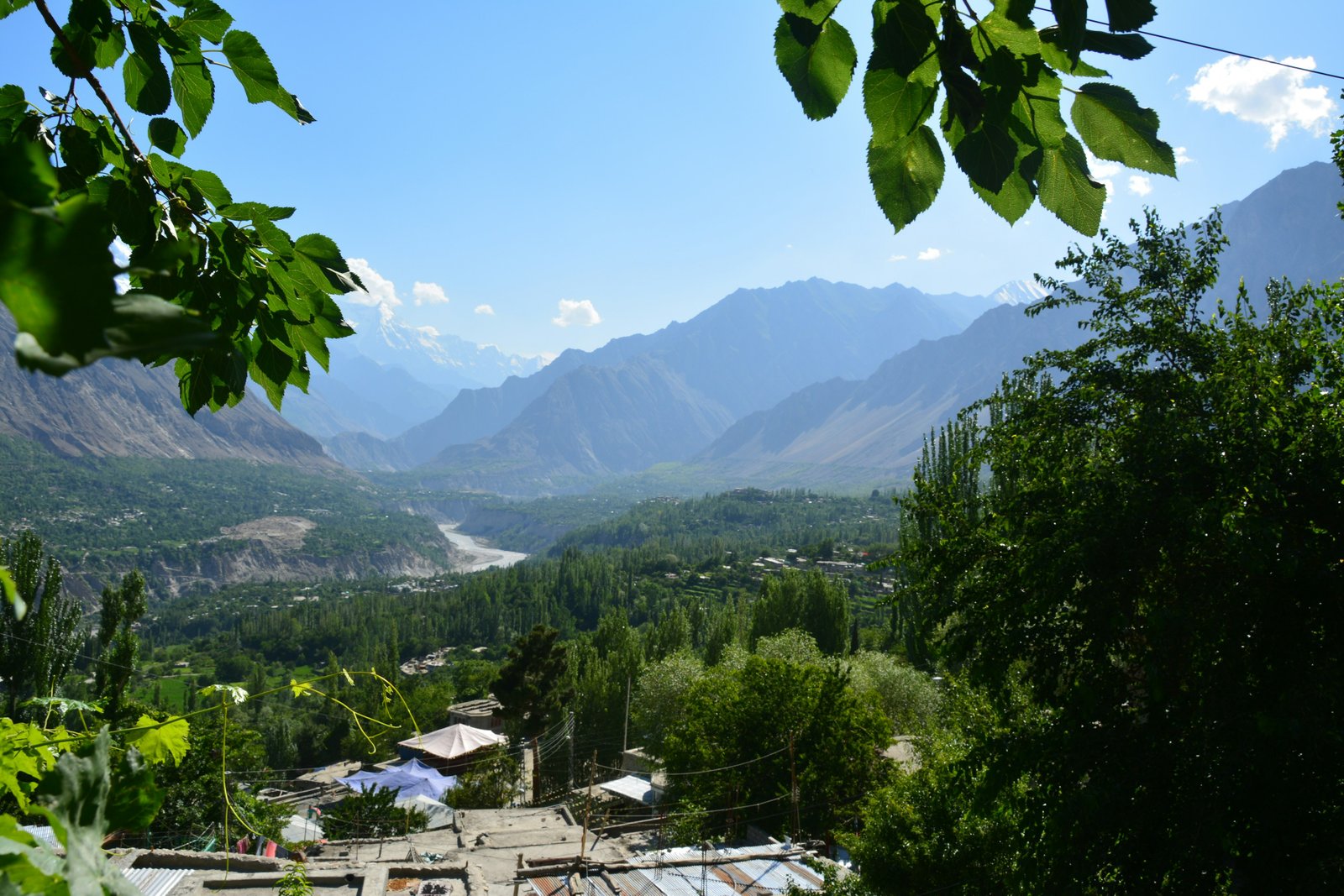 A green valley in Hunza with mountains beyond